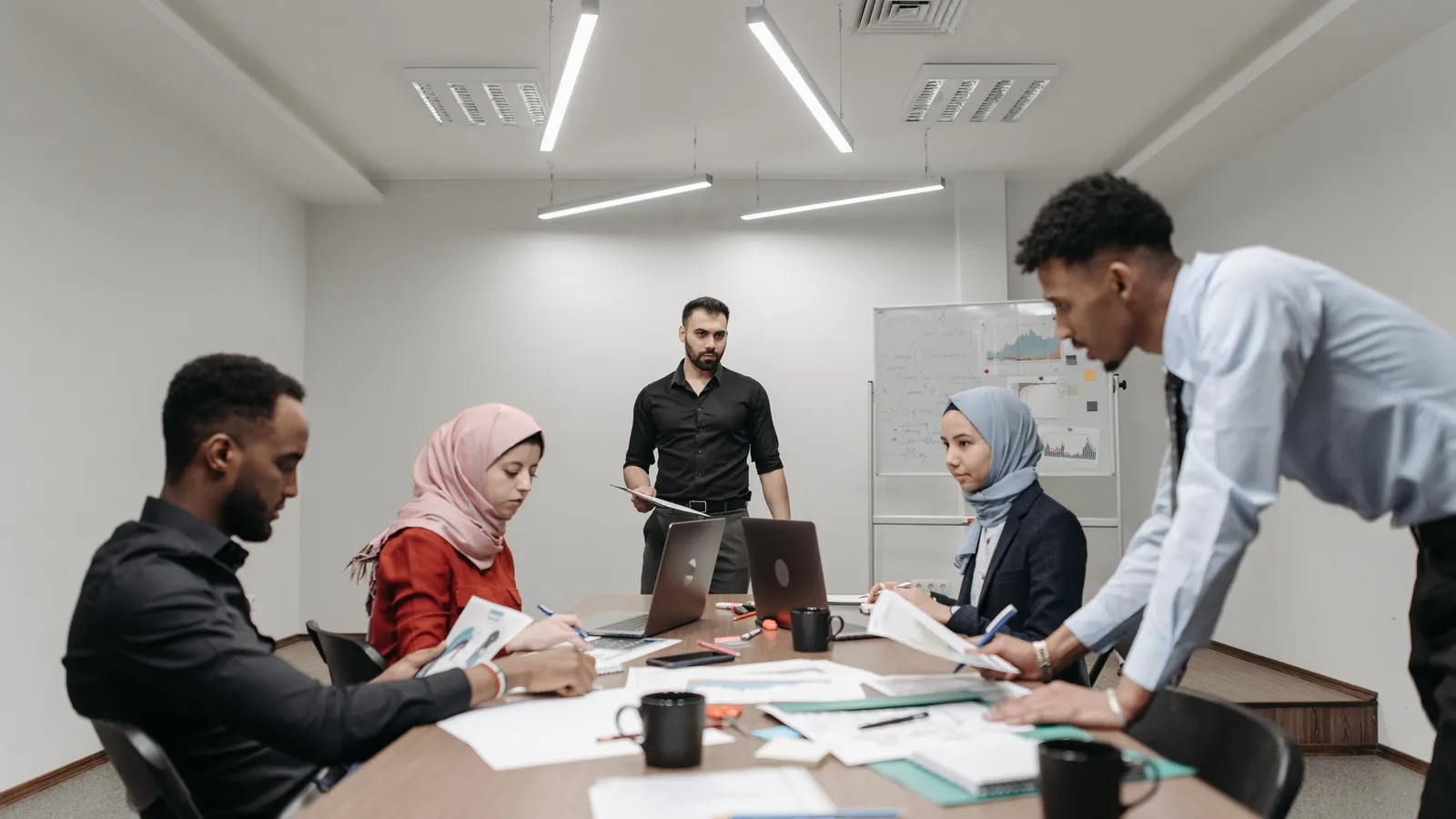Employees and managers in a team meeting learning practical AI work skills
