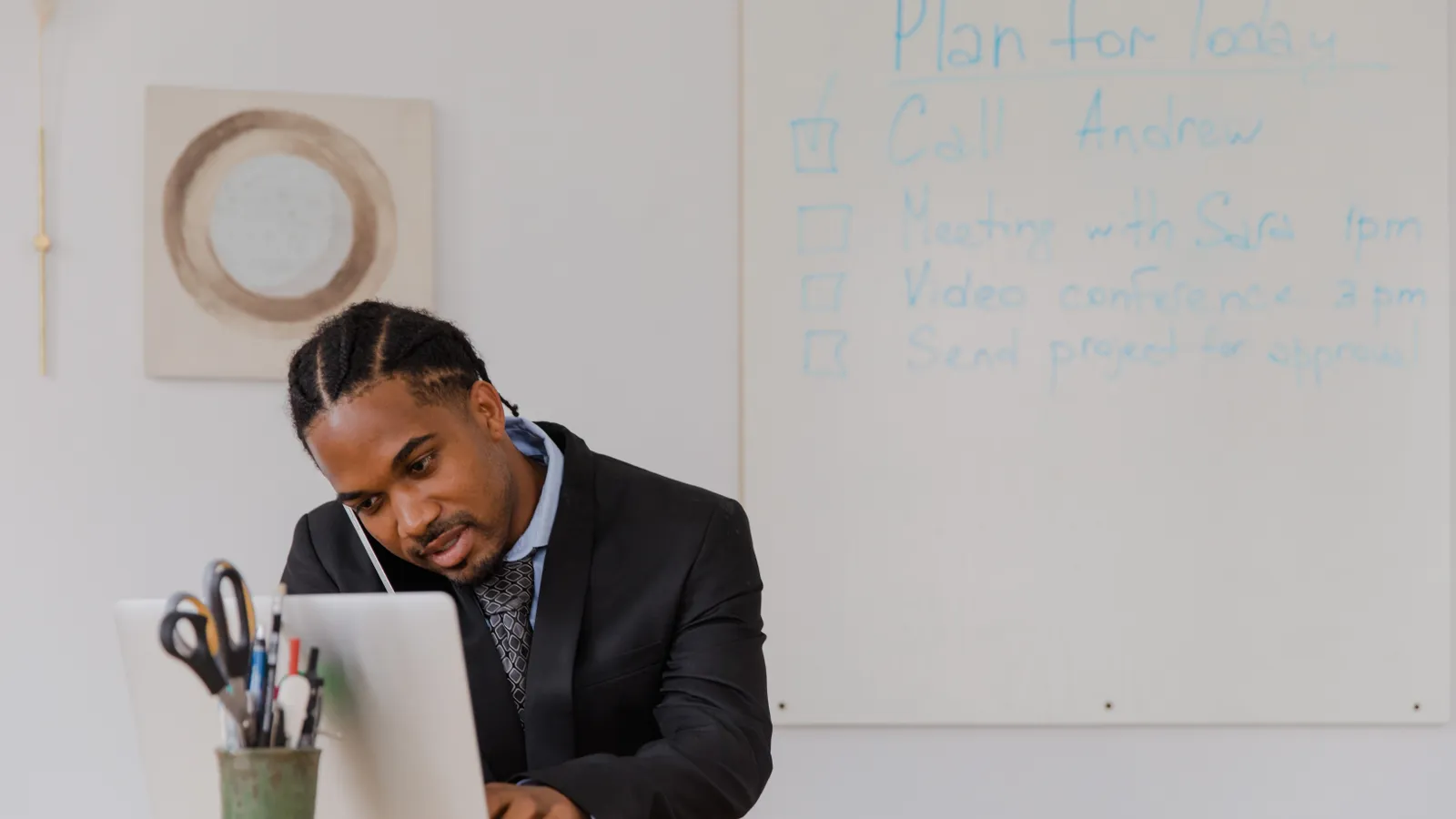 Local business owner using a phone and laptop to respond to new leads