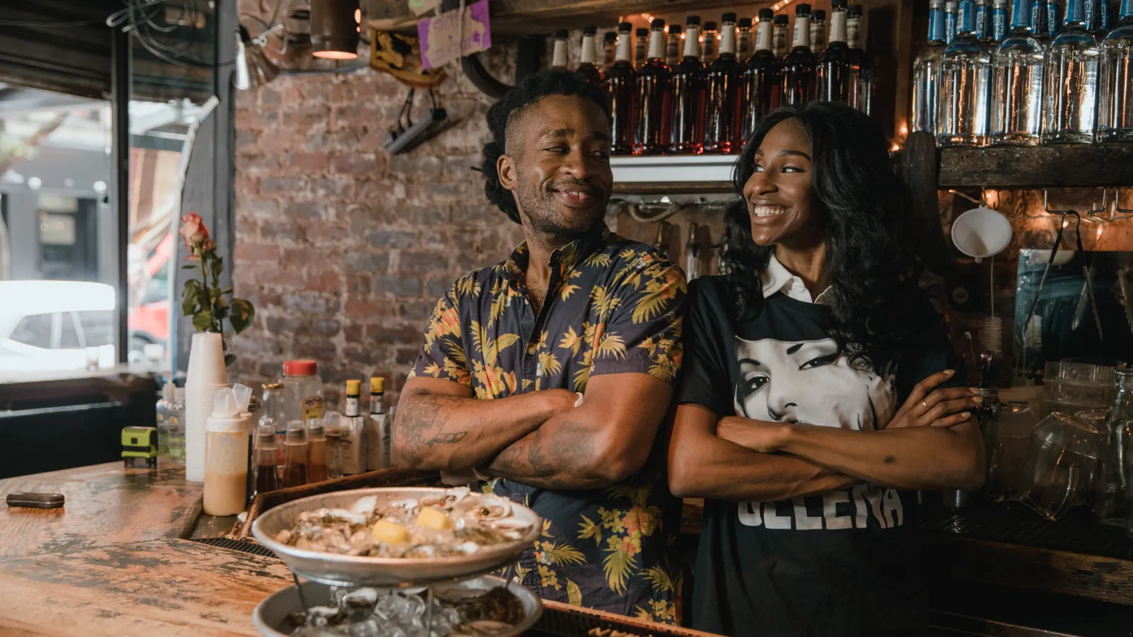 Local service business owners in a restaurant using AI for practical marketing
