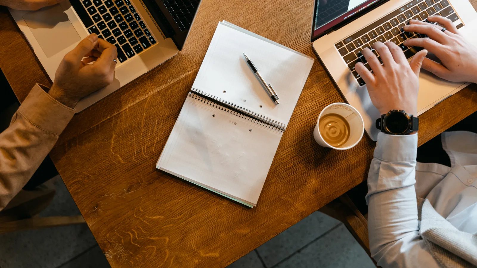 Workspace with laptops and notes for AI productivity at work