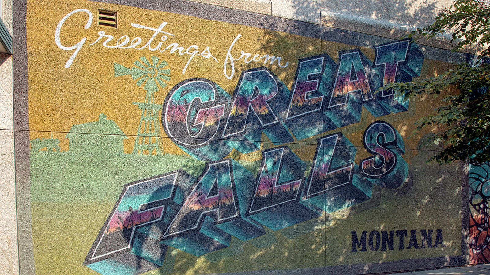 Downtown postcard-style mural welcoming visitors to Great Falls, Montana